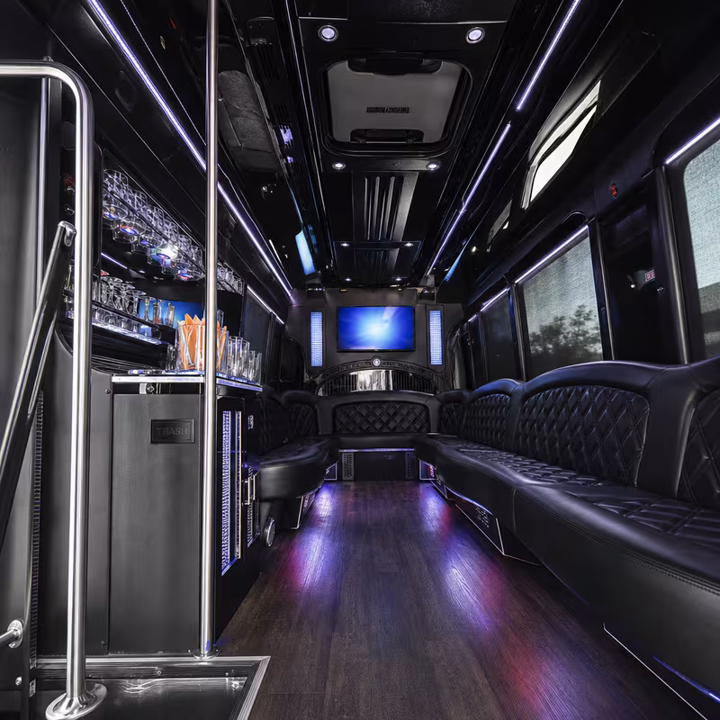 Party bus interior with wraparound leather seating and LED lighting in Omaha