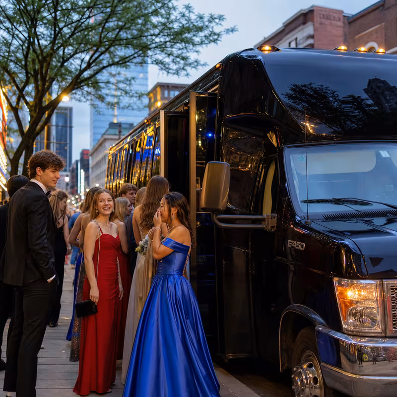 Passengers loading luggage while boarding an Omaha group shuttle