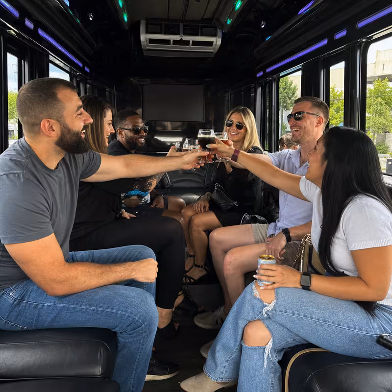 Group boarding a white charter bus for Winery & Brewery Tour Transportation transportation in Omaha